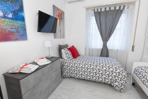 a small bedroom with a bed and a window at Baglioni Vatican House in Rome