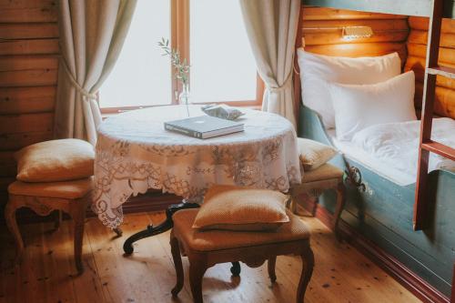a room with a table with a bed and a book on it at Tuddal Høyfjellshotel in Tuddal