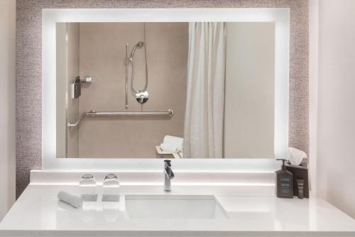 a bathroom with a sink and a shower at Sheraton Hotel Stonebriar in The Colony