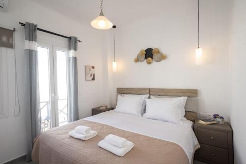 a bedroom with a bed with two towels on it at My White Studio Mykono Town in Mýkonos City