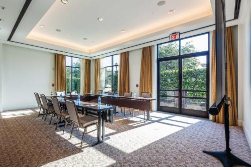 a conference room with a table and chairs and windows at Sheraton Hotel Stonebriar in The Colony