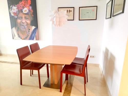 a dining room with a wooden table and chairs at Los Arqueros Las Jacarandas in Benahavís