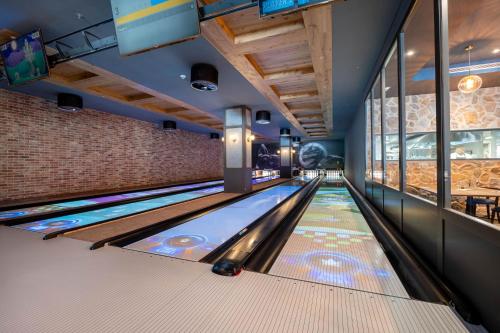an empty bowling alley with lanes in a building at Swissôtel Damian Jasna in Demanovska Dolina