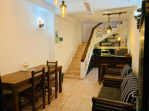 a dining room with a table and chairs and a staircase at No 31 in Galle