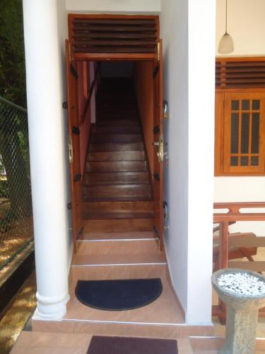a staircase leading up to a house with a door at The Cool Nest Yala Hotel in Tissamaharama