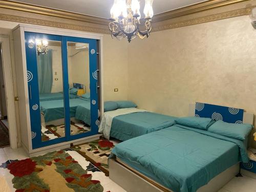 a bedroom with two beds and a mirror at LuXury Apartment Nasr City - CityStars in Cairo
