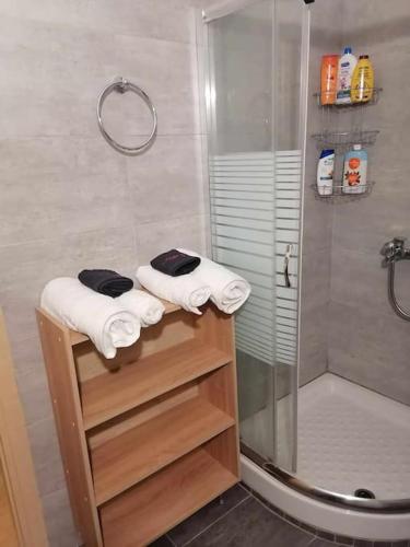 a bathroom with a shower and white towels at Filoxenia.kom in Athens
