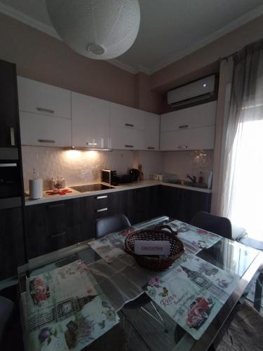 a kitchen with a glass table with chairs and a counter at Anthi's house in Preveza