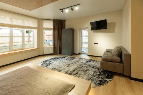 a living room with a couch and a television at Discovery Garden apartments in Khmelʼnytsʼkyy