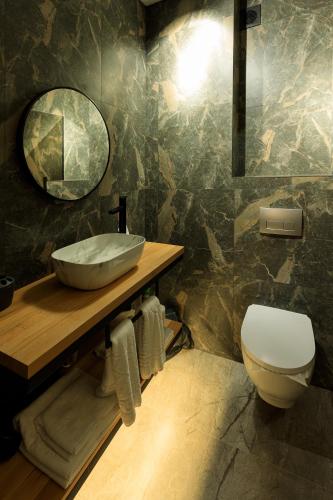 a bathroom with a sink and a toilet at Discovery Garden apartments in Khmelʼnytsʼkyy