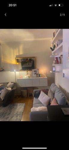 a living room with a couch and a table at Résidence billancourt in Boulogne-Billancourt