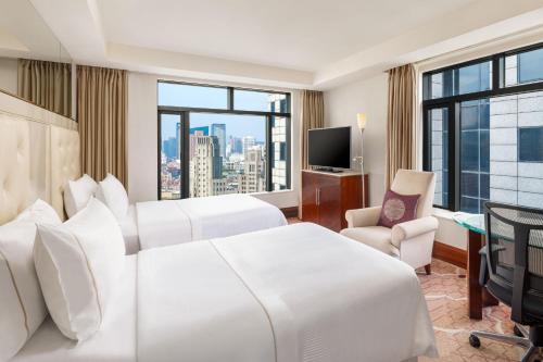 a hotel room with two beds and a large window at The Westin Bund Center, Shanghai in Shanghai