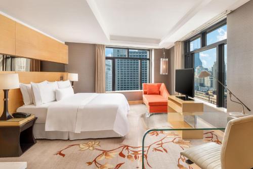 a bedroom with a large white bed and a large window at The Westin Bund Center, Shanghai in Shanghai