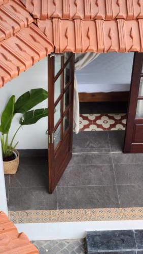 a room with a bed with a wooden door at Anio Ha Giang Hotel in Ha Giang