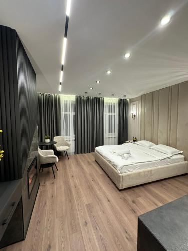 a bedroom with a large bed and a desk at LEOGRAND Apartments on Virmenska 14 in Lviv