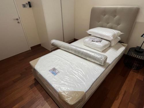 a bed in a room with two pillows on it at Homestay KLGCC KL Golf Country Club Senada Residences in Kuala Lumpur