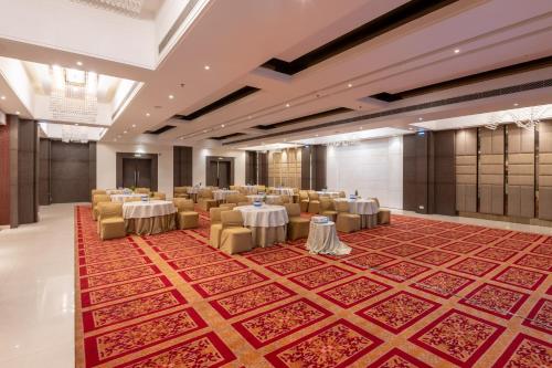 a banquet hall with tables and chairs in a room at Ramada by Wyndham Kasauli in Kasauli