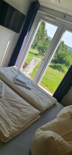 a bedroom with two beds in front of a window at Haus Chios in Birgland