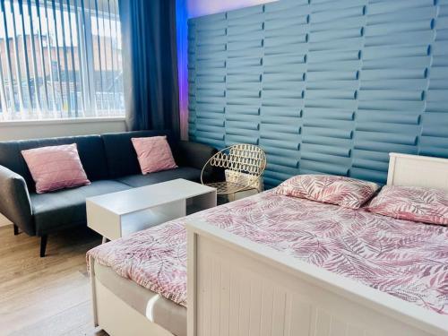 a living room with a bed and a couch at City Studio Apartment Swansea - Includes Free Parking in Swansea