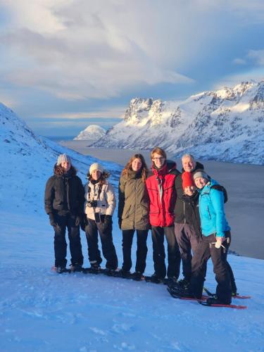 a group of people posing for a picture in the snow at Lund - Exellent Apartment in Tromsø
