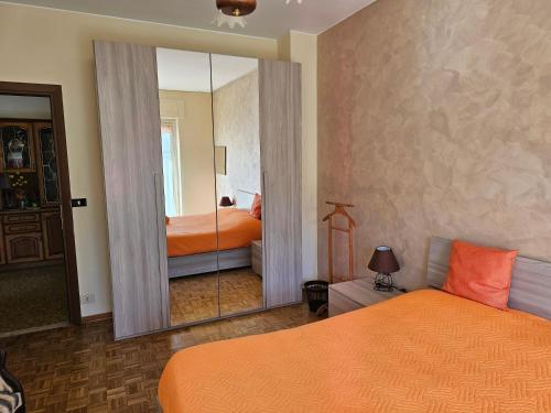 a bedroom with two beds and a large mirror at Il Sole di Sanremo in Sanremo
