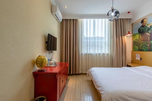 a hotel room with a bed and a television at Happy Dragon City Center Alley Hotel -In the city center with big window&heater, ticket service&Free Coffee&Food recommendation,Near Tian Anmen Forbiddencity,Easy to get traditional Walking area&Shichahai in Beijing