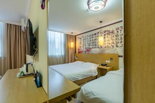 a hotel room with two beds and a mirror at Happy Dragon City Center Alley Hotel -In the city center with big window&heater, ticket service&Free Coffee&Food recommendation,Near Tian Anmen Forbiddencity,Easy to get traditional Walking area&Shichahai in Beijing