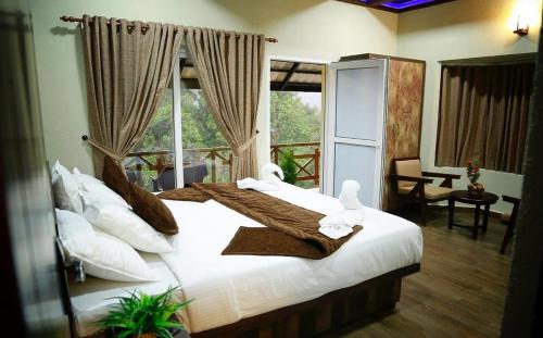 a bedroom with two beds with towels on them at The RaaRees Resort - A Hidden Resort in Munnar in Munnar