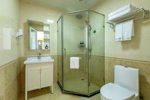 a bathroom with a shower and a toilet and a sink at Happy Dragon City Center Alley Hotel -In the city center with big window&heater, ticket service&Free Coffee&Food recommendation,Near Tian Anmen Forbiddencity,Easy to get traditional Walking area&Shichahai in Beijing