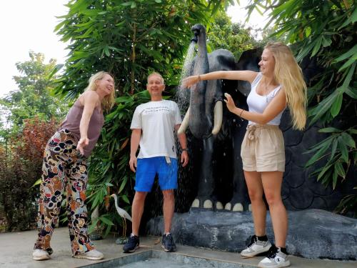 a group of people standing in front of a fountain at Sigiriya Cashew Palace Resort in Daganapothaha