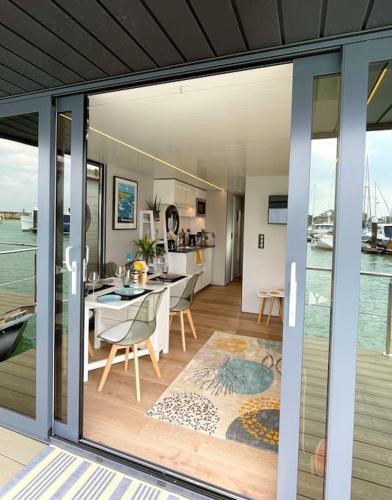 a kitchen and dining room with a view of the water at Yarmouth Waterlodge Floating Apartments 2 in Yarmouth