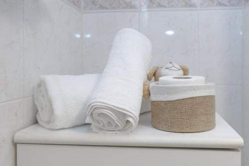 a pile of towels sitting on top of a toilet at Pigneto Smart Apartment in Rome