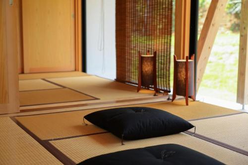 a meditation room with a black pillow on the floor at Ryukyu Villa - Vacation STAY 11899v in Akaoki