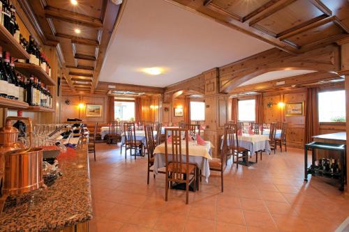 a dining room filled with tables and chairs at Hotel Krone in Livigno