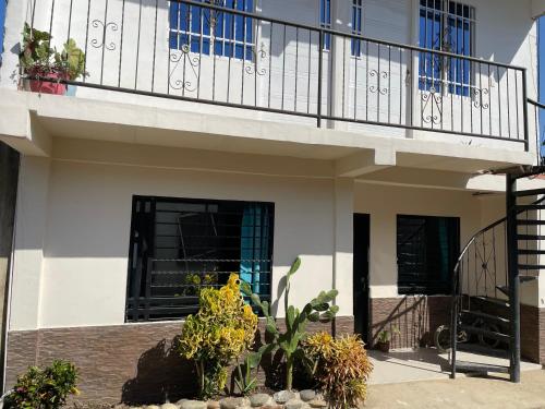 a house with a balcony with plants on it at La Casa de Ian in Santa Marta