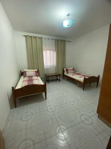 a bedroom with two beds in a room at Tota apartments in Shkodër