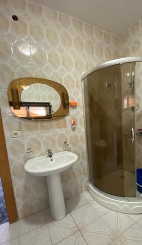 a bathroom with a sink and a shower at Tota apartments in Shkodër