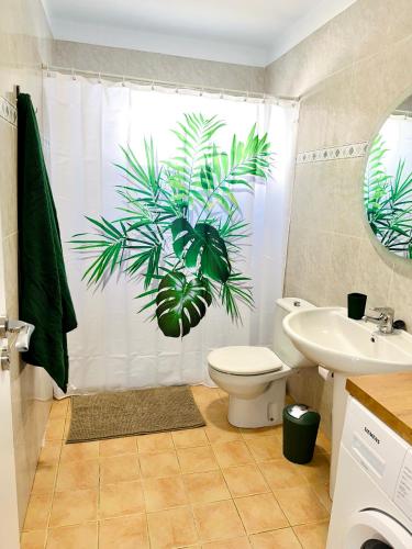 a bathroom with a shower curtain with a plant on it at Hope house Lanzarote in Puerto del Carmen