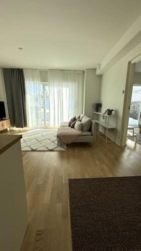 a living room with a couch and a table at 2 Bedroom Rose Charm - by University in Kokkola
