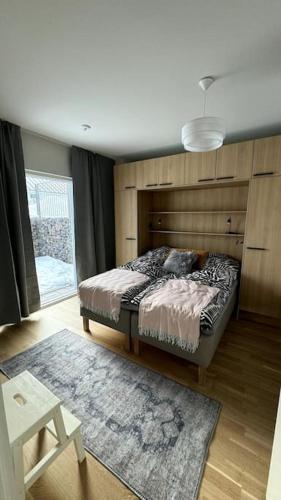 a bedroom with a bed and a large window at 2 Bedroom Rose Charm - by University in Kokkola