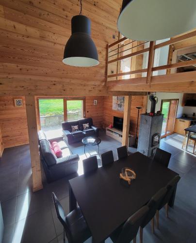 un salon avec une table et un canapé dans l'établissement Chalet des Jonquilles - Au calme, bordant la forêt, à Gerbépal