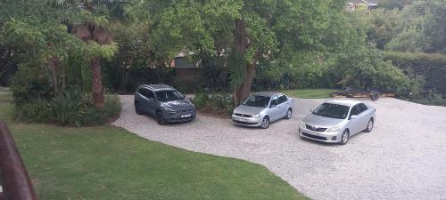 three cars parked in a gravel parking lot at 62 on Adderley in George