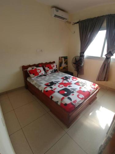 a bedroom with a bed with a cow comforter at Appartement luxueux de Bonaberi in Douala