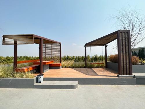a pavilion with a bench and a table at East Ville-45 in Ban Hua Khao Sammuk