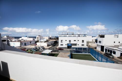 a view of a city from the roof of a building at AmuraHouse. Private terrace BBQ. Centric and cosy. in Cotillo