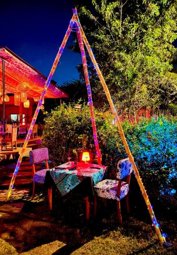 a table and chairs with a table and a tent at Le Patio in Lomé
