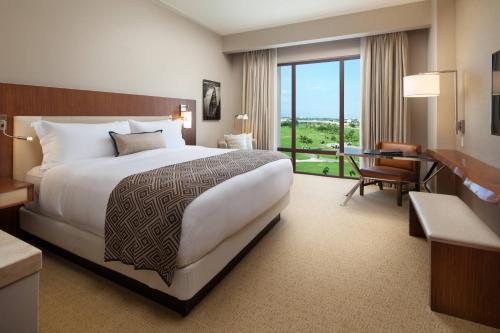 a hotel room with a large bed and a desk at The Santa Maria, a Luxury Collection Hotel & Golf Resort, Panama City in Panama City
