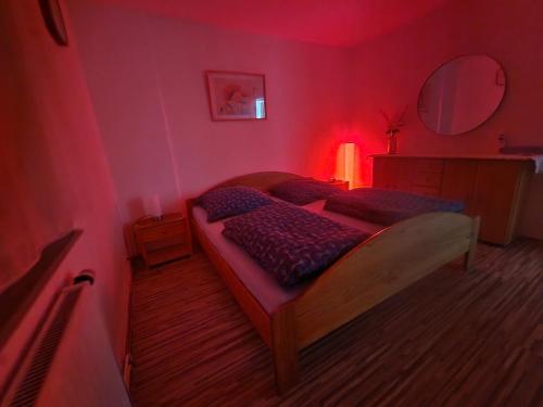 a bedroom with a bed in a red room at Holiday Apartment near Triberg Waterfall in Triberg