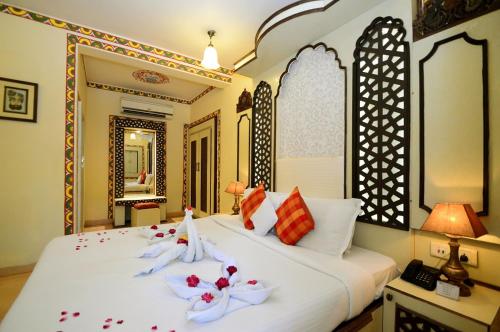a bedroom with a bed with towels on it at CHOKHI DHANI INDORE in Indore