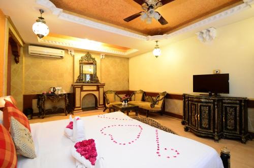 a room with a bed and a tv and a room with at CHOKHI DHANI INDORE in Indore